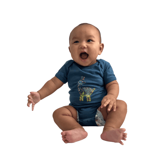 Baby wearing a onesie in blue with handmade llama in fiesta cotton batik fabric.