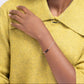 Woman in a yellow sweater wearing a sterling silver bracelet with four black onyx beads.