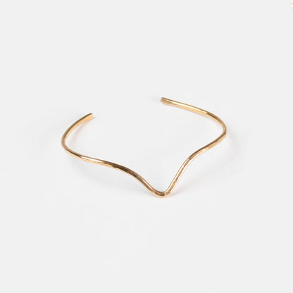The Emily Brass Bangle on a white background, modern and classic.