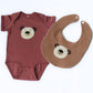 Baby onesie and bib with bear design on a white background