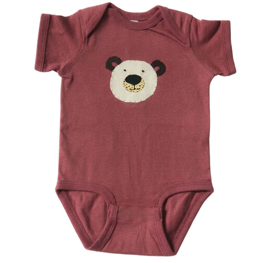 mauve baby onesie with a bear face design on a white background