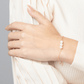 Classic bracelet on a 14k Gold Filled chain with three freshwater pearls showcased on a woman's wrist.