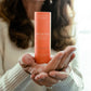 Woman holding Thistle Farms essential oil roll-on Eucalyptus Peppermint "Breathe" blend in her hands.