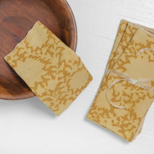 Set of block printed cotton napkins with yellow flowers on a white background