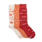 Three pairs of socks in white, orange, and red with various patterns with butterfly embroidery on a white background.