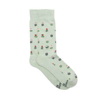 Light green crew socks with floral pattern on a white background