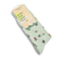 Green socks with tulips and a packaging label  that says socks that plant trees on a white background