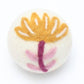 Yellow and pink flower dryer ball made with 100% organic wool. Fair Trade.