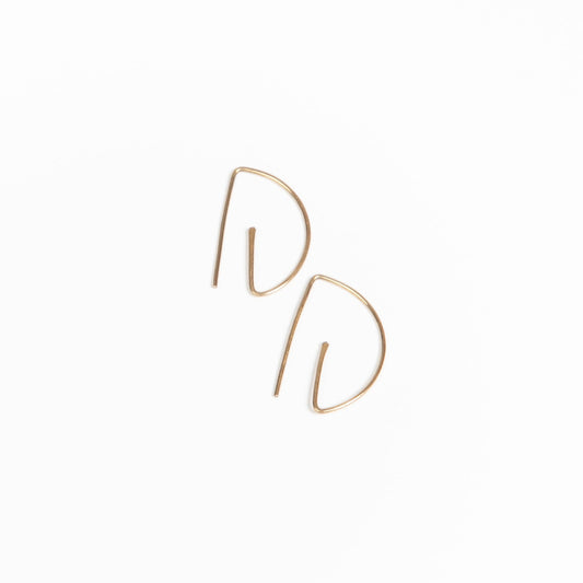 Close-up sideview of woman wearing earring stack with Half Moon Hammered Threader Earrings, Journey of Hope Huggie Earrings and Ear Cuff in 14k Gold Filled.