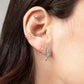 Closeup of woman wearing Journey of Hope Ear Cuff and Huggie Earrings   in 14k gold filled paired with Moab Western Turquoise Beaded Earrings.