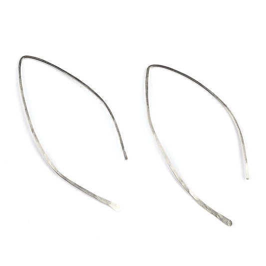 A side profile of a young woman wearing Qasioun Minimalist Threader Earrings in sterling silver.