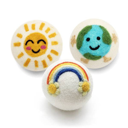 White felt ball with a rainbow and flowers on a white background