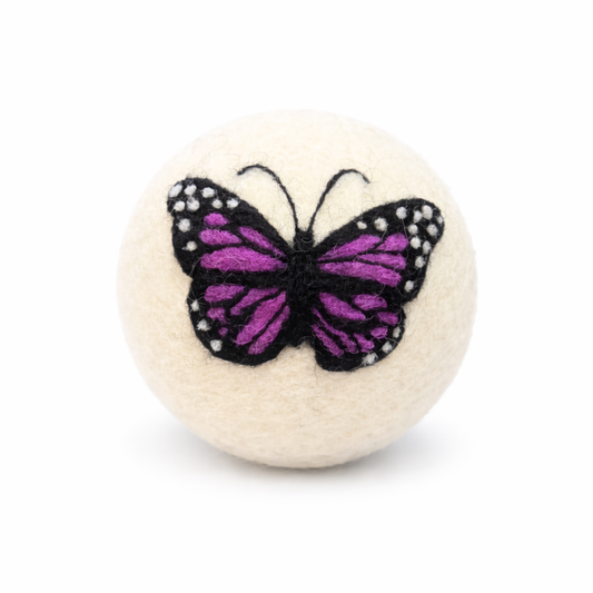 hand felted dryer ball with butterfly design on a white background