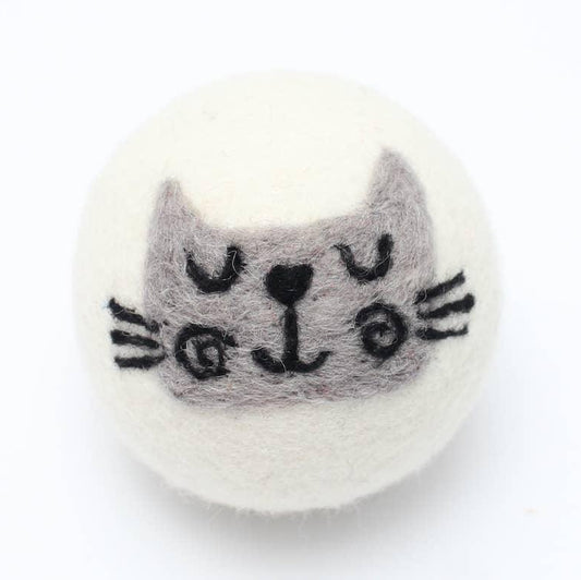 a reusable wool dryer ball with a cute gray cat face design on a white background