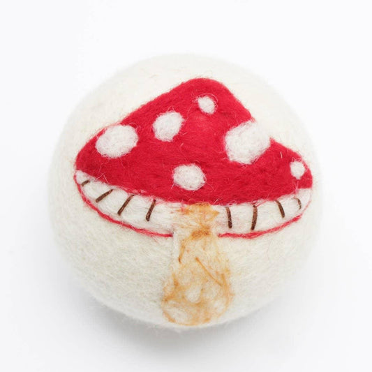Felted mushroom design on wool dryer ball on a white background
