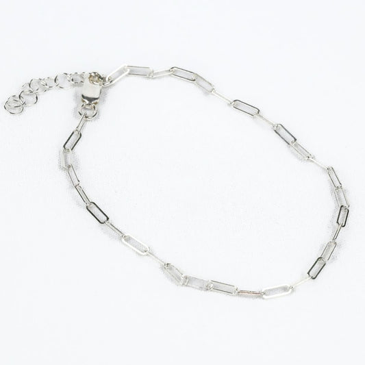 a sterling silver paperclip chain bracelet with an extension chain on a white background