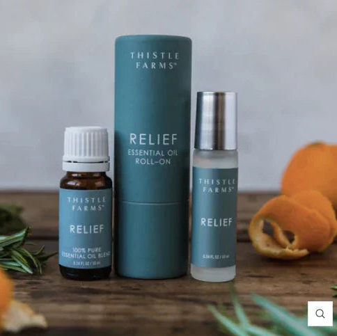 Thistle Farms Relief essential oil roll-on bottle and packaging on a white background