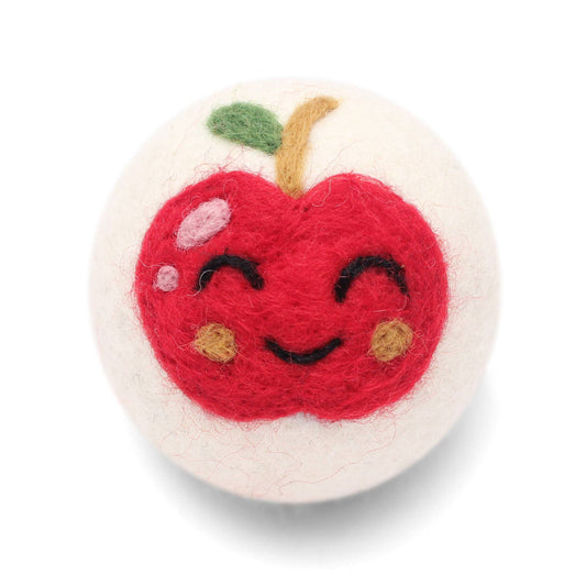 Felted apple-shaped wool dryer ball with a smiling face on a white background