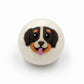 felted wool dryer ball with a dog face design on a white background