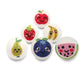 Set of colorful felted wool dryer balls with fruit designs on a white background