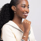 Woman in sailor-style sweater wearing Leeda Freshwater Pearl Leverback Earrings, Necklace and Bracelet in 14k gold filled.