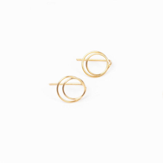 A young woman wearing Zomi Open Circle Earrings and Zomi Circles of Unity Necklace in 14k gold filled.