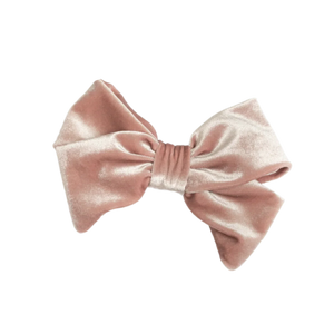 A rose gold velvet hair bow barrette.