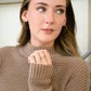 blonde model wearing gold hoop earrings and double wrap ring