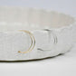 two pairs of simple hoop earrings, one gold and one silver, on a dish