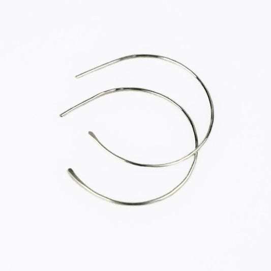blonde model wearing simple sterling silver hoop earrings