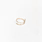 an adjustable single ring made of brass on a white background