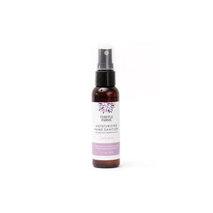Thistle Farms moisturizing hand sanitizer bottle on a white background