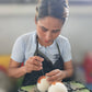 Woman hand-sewing felted wool dryer ball