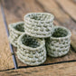 Set of woven napkin rings on a wooden surface