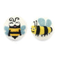 two felted wool dryer balls with different cute happy bee designs on a white background