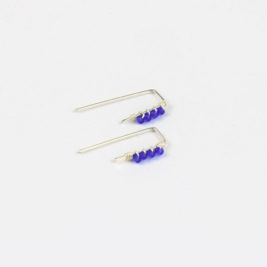 pair os tiny silver threader earrings with royal blue beads