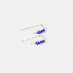 pair os tiny silver threader earrings with royal blue beads