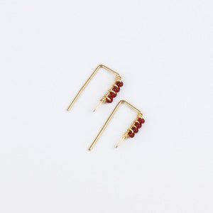 tiny gold threader earrings with four red glass seed beads