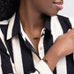 Woman in a black and white striped shirt wearing Jordan Black Onyx Necklace, Bracelet, and J Hoop Earrings in 14k gold filled.