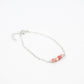 silver chain bracelet with four pink rhodonite beads at the center