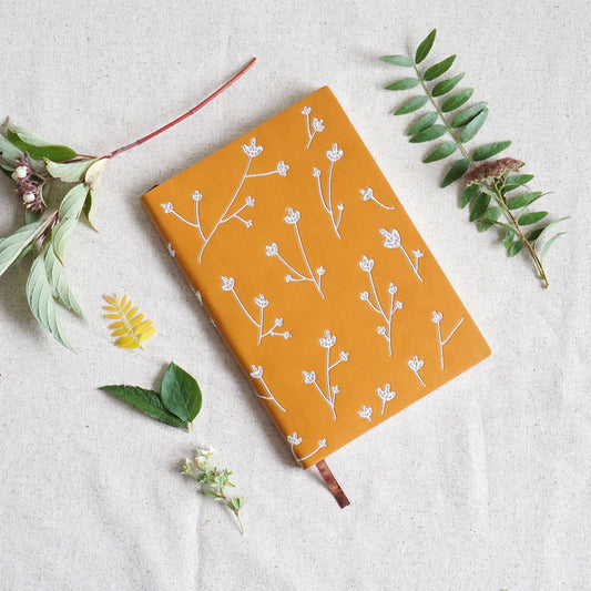 Layflat embroidered floral journal notebook that supports schools. 
