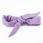 Purple knotted headband on a white background