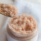 Open jar of Thistle Farms exfoliating Lavender Body Scrub.