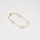 gold chain bracelet with four pearls set at separate stations