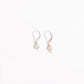 Pair of freshwater pearl leverback earrings in sterling silver on a white background
