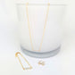 gold necklace, bracelet and earrings, all adorned with silver beads, on a white background