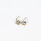 pair of gold earrings with silver bead at the center