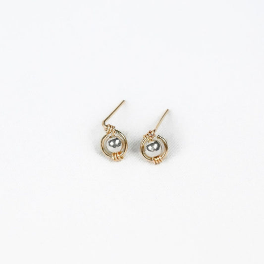 pair of gold earrings with silver bead at the center