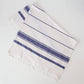 White towel with blue stripes on a light gray background