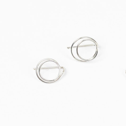 A young woman wearing the Zomi Open Circle Earrings in Sterling Silver, featuring a double circle and mini-threader design.